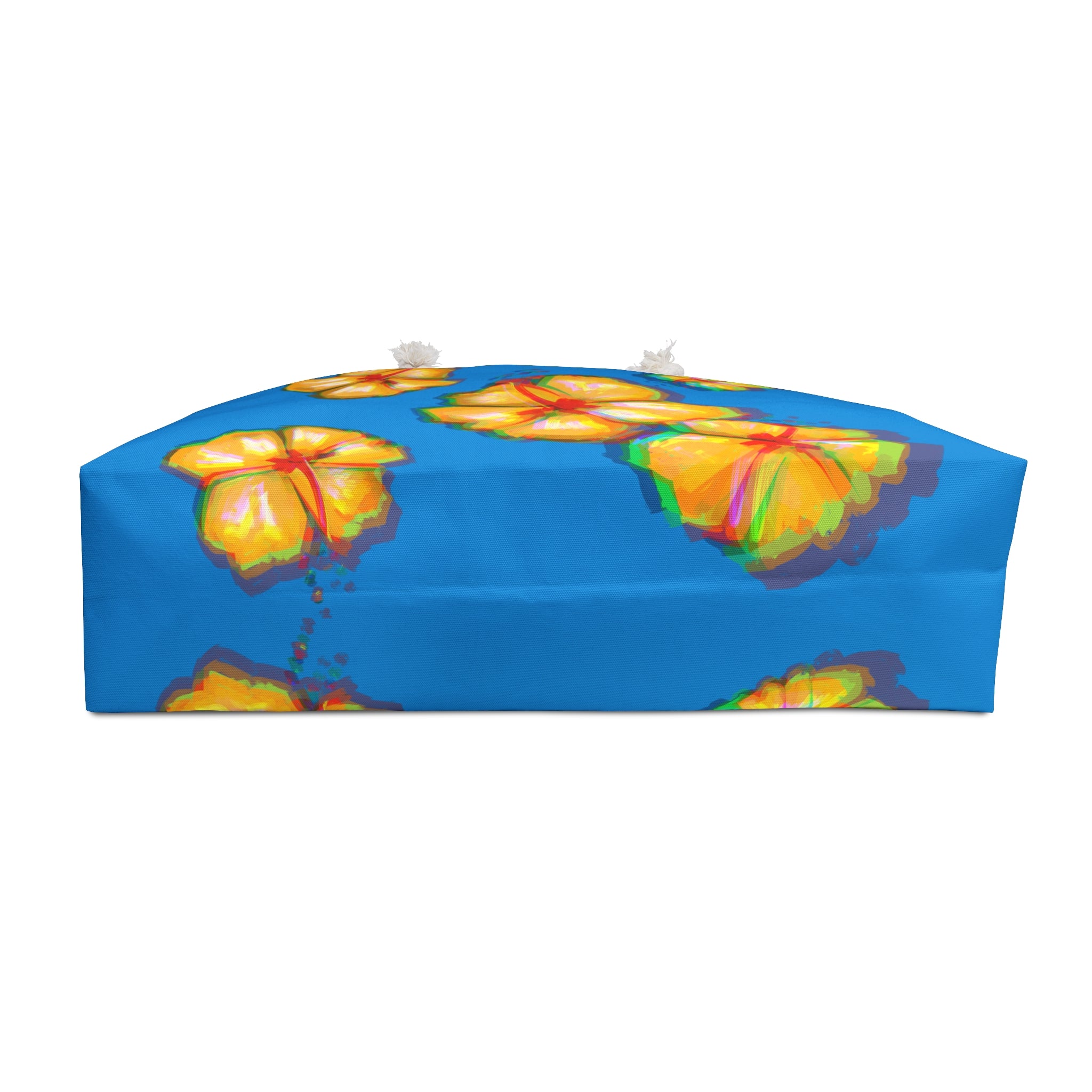 bottom view of a colorful beach bag with colorful hibiscus design on a blue background
