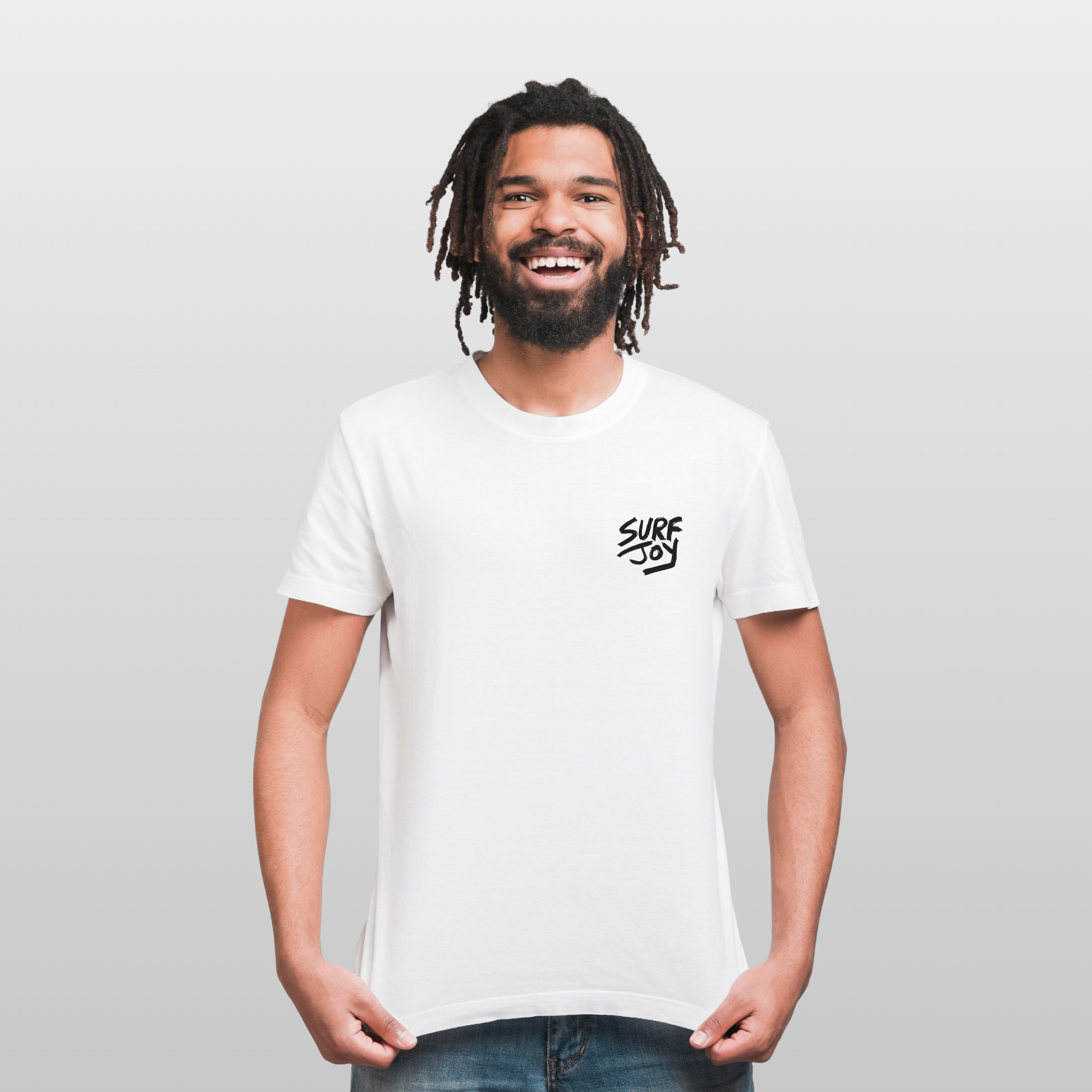 Smiling man wearing a white t-shirt with 'Surf Joy' logo on a plain background