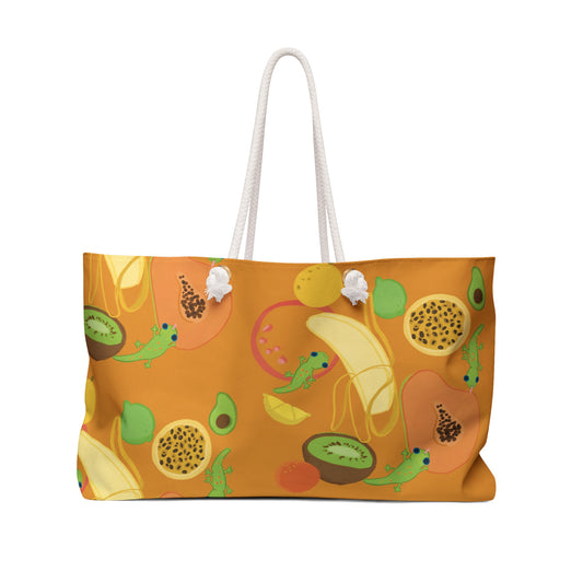 large orange beach bag with rope handles and pattern of tropical fruits and geckos with banana papaya kiwi lilikoi avocado hawaii fruits