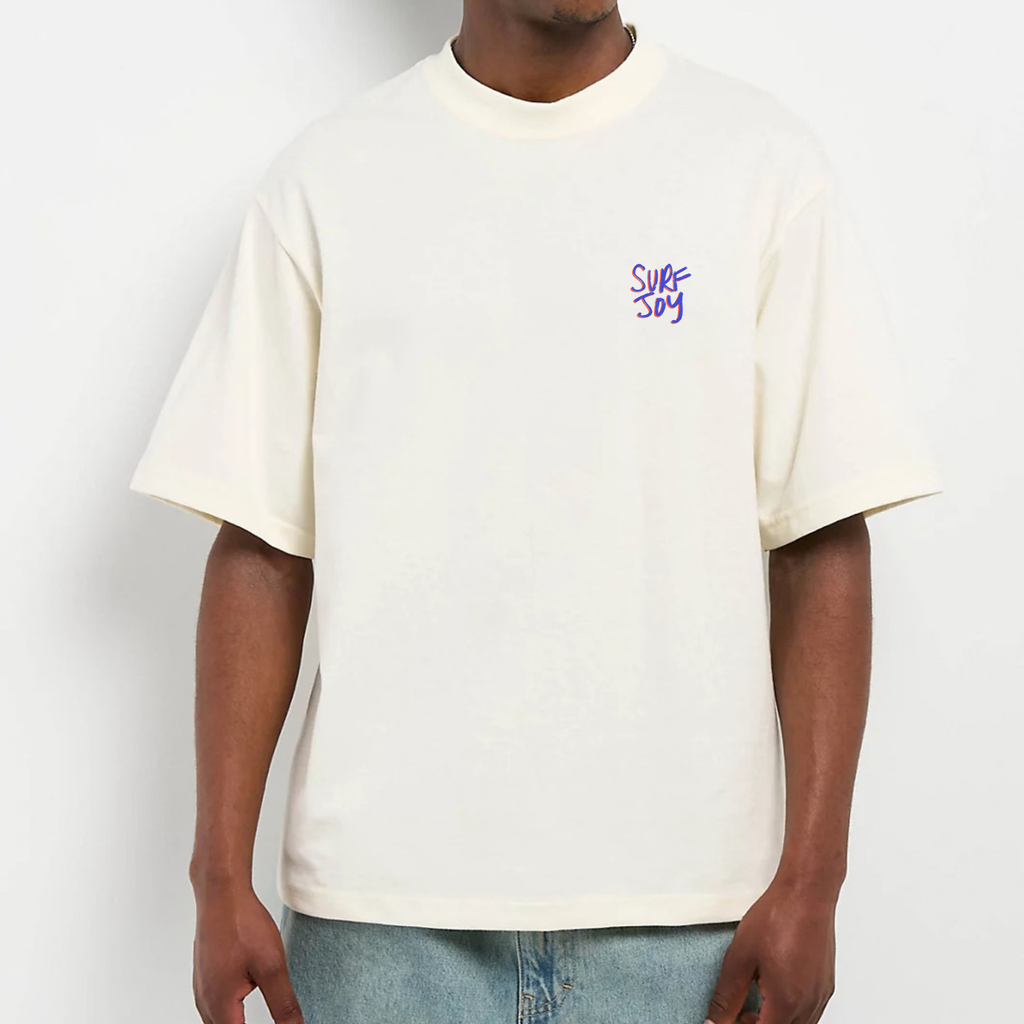 Front view of model wearing an oversized surfjoy t-shirt with a neutral background