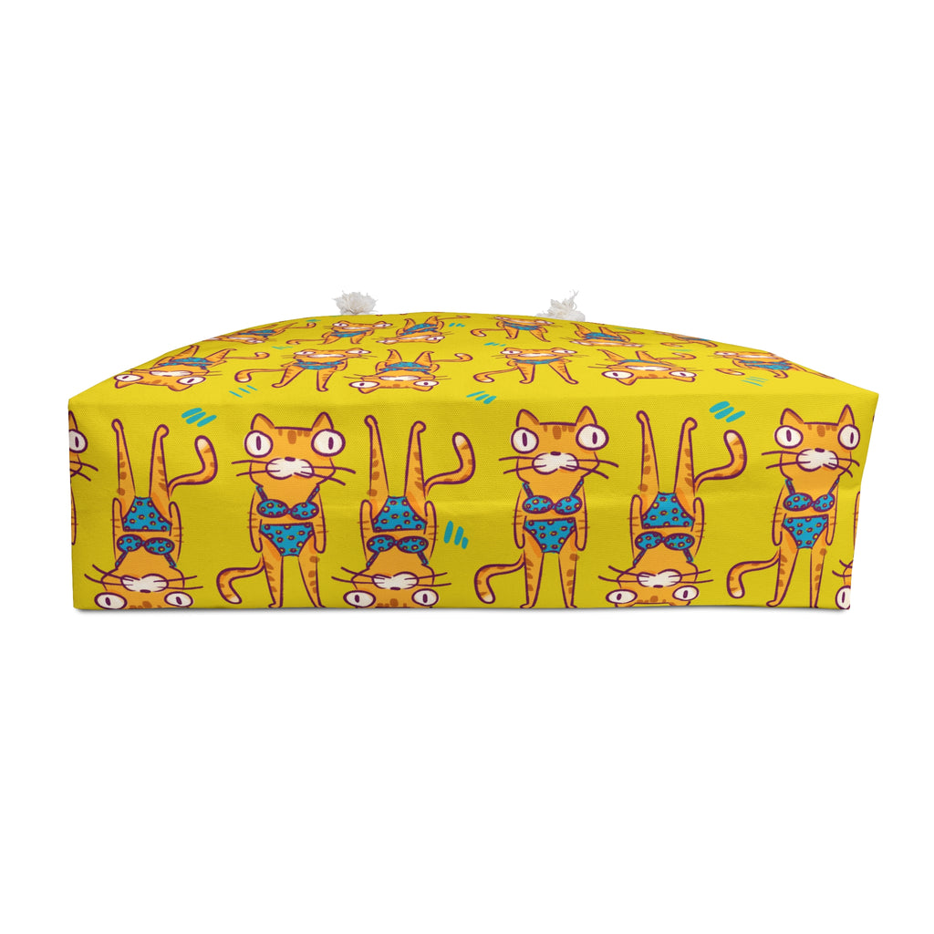 Yellow beach bag with cartoon cat design on a white background