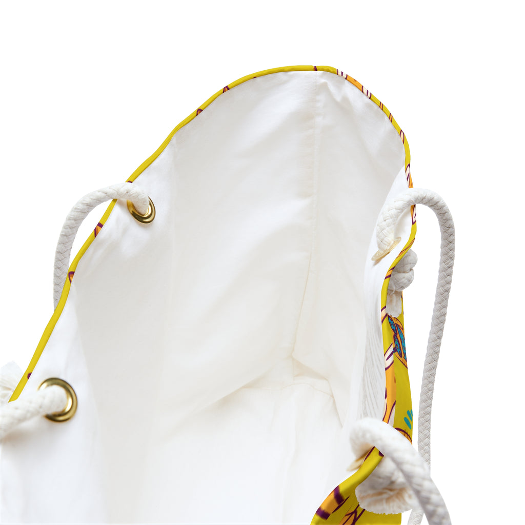 Close-up of a white drawstring bag with yellow accents on a white background