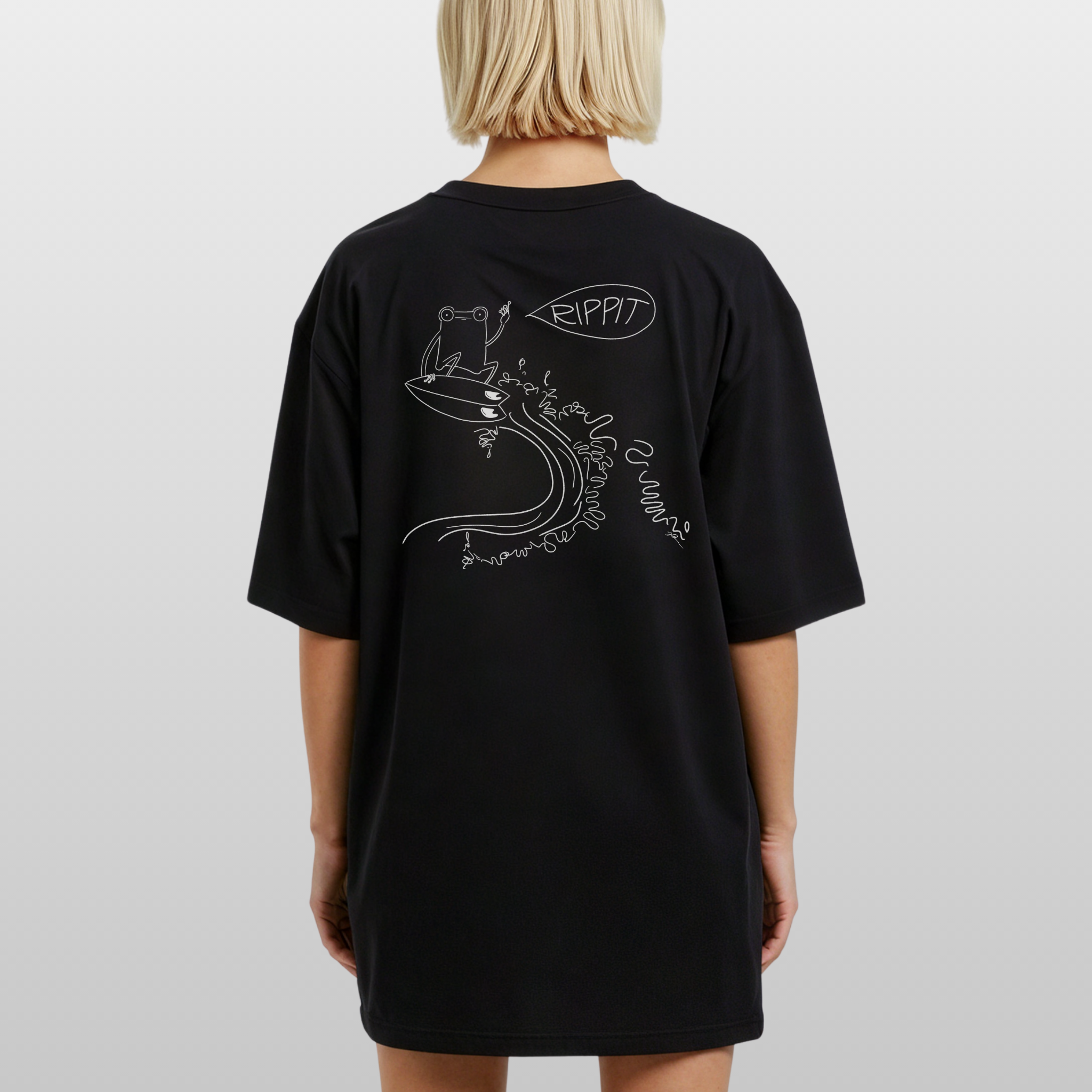 blonde haired model wearing a black surfjoy t-shirt featuring a design of a frog catching an air on a wave with a speech bubble that says 'rippit'