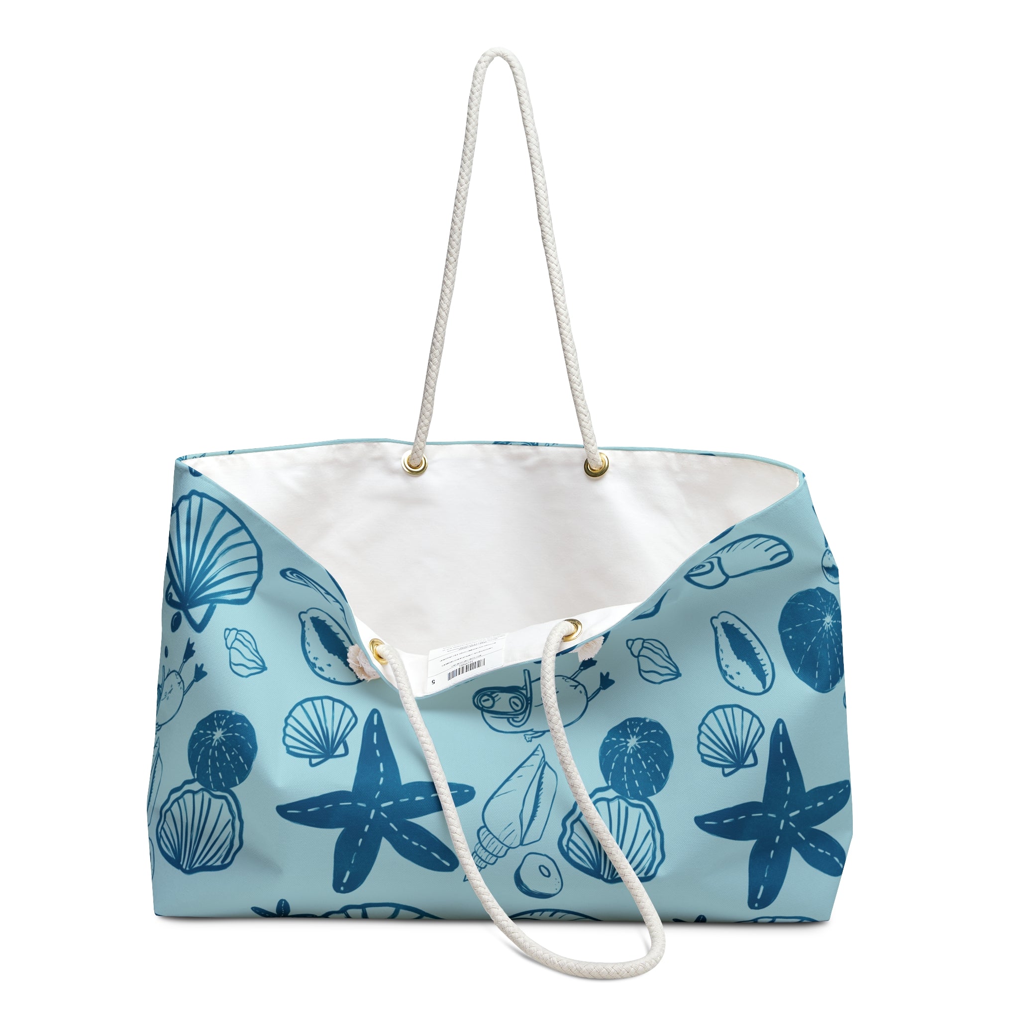 Blue beach bag with blue seashell pattern on a light blue background