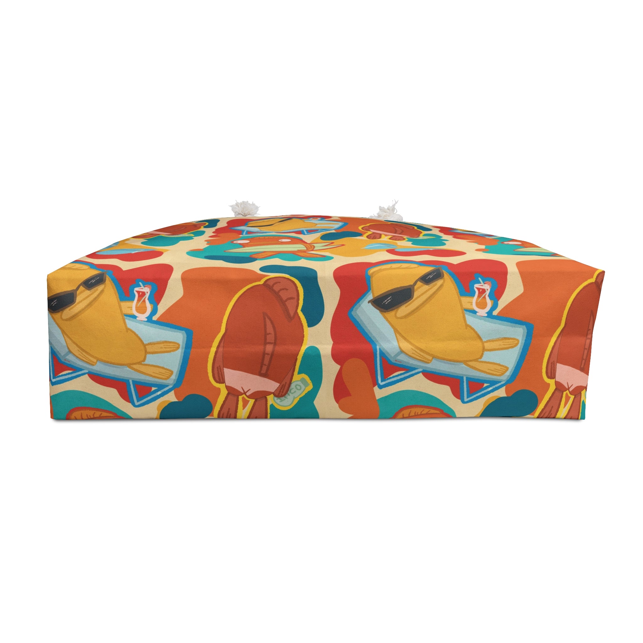 bottom view of an oversized beach bag with a groovy all over print of cute fish characters on the beach