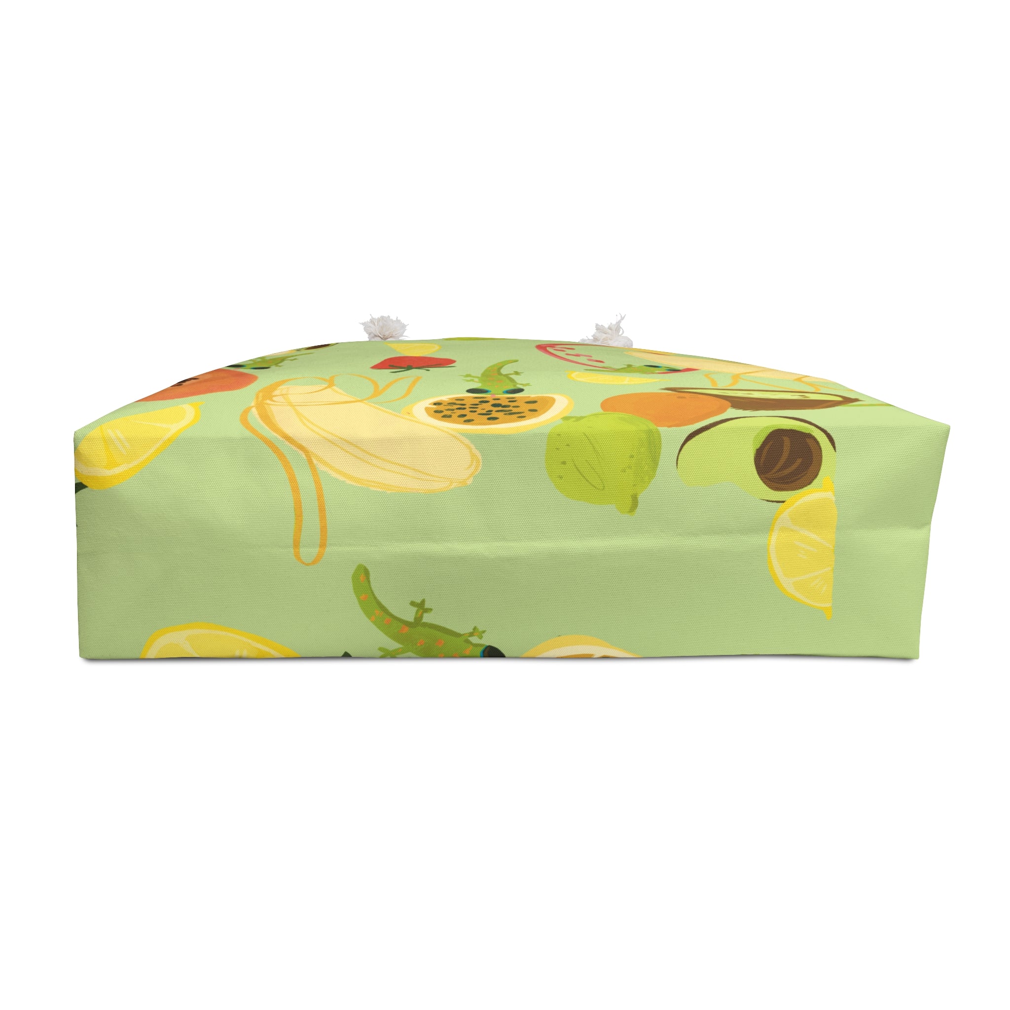 bottom view of a cute lime green oversized beach bag with a tropical fruits and gecko pattern
