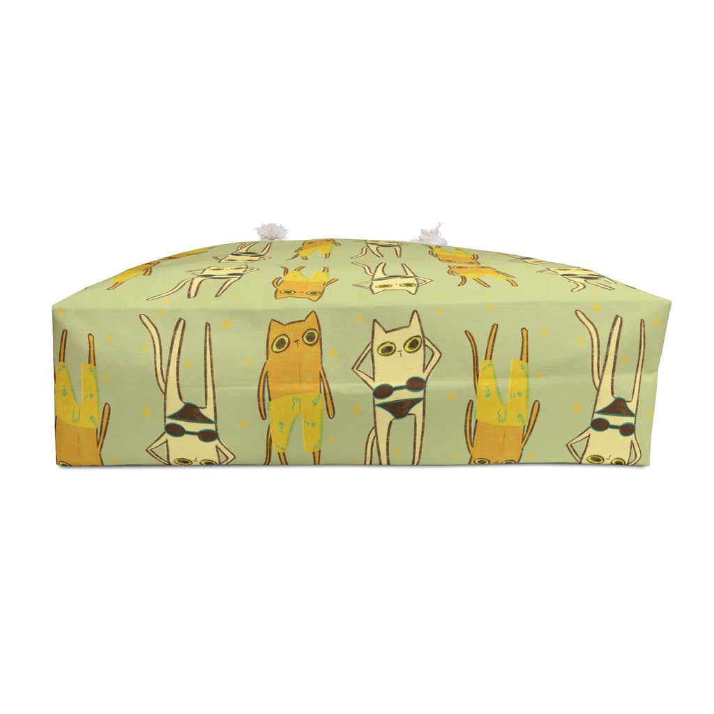 bottom view of an oversized green beach bag featuring an all-over print of cats in swimsuits in funky 90s style illustration