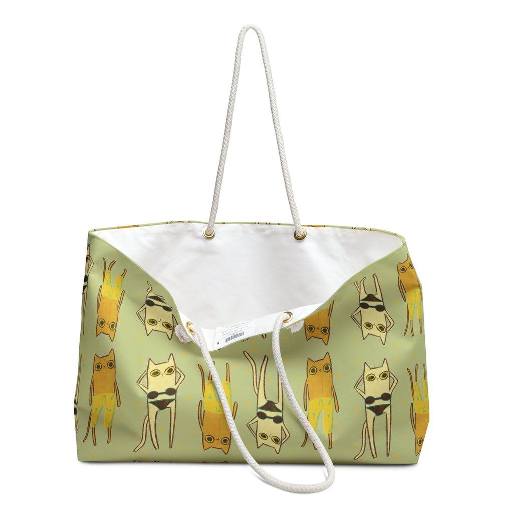 open beach bag view of an oversized green beach bag featuring an all-over print of cats in swimsuits in funky 90s style illustration