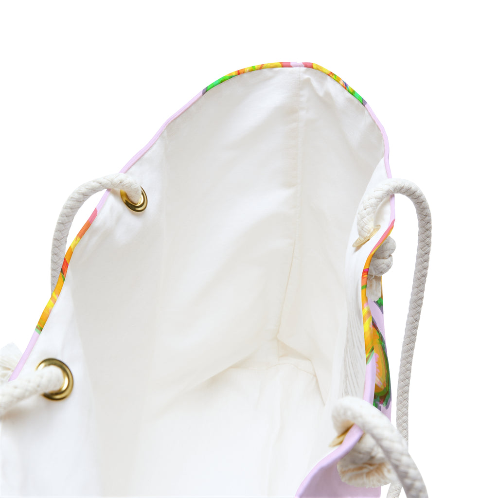 view of inside of hibiscus pattern beach bag showing the cream colored liner