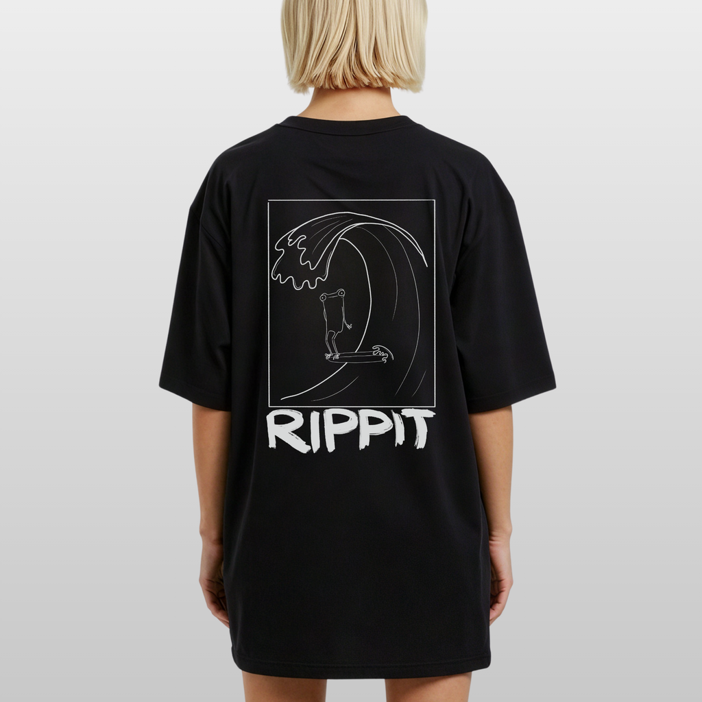 back view of a blonde woman wearing a black surfjoy t-shirt with a design of a surfing frog and text that says 'rippit'