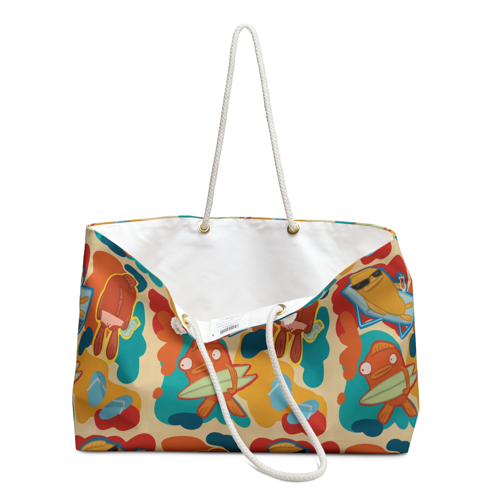 open oversized beach bag with a groovy all over print of cute fish characters on the beach