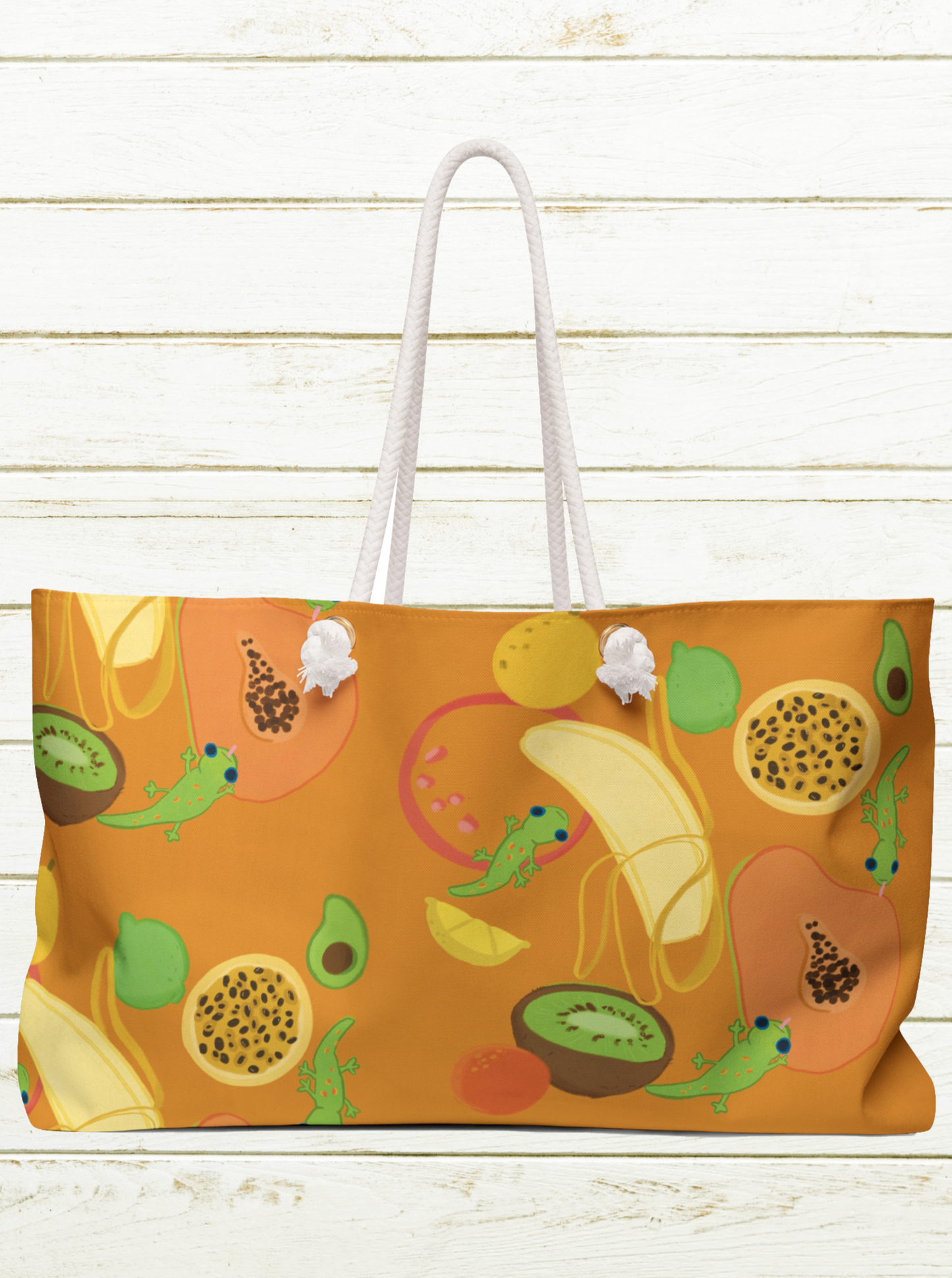 large orange beach bag with rope handles and pattern of tropical fruits and geckos with banana papaya kiwi lilikoi avocado hawaii fruits