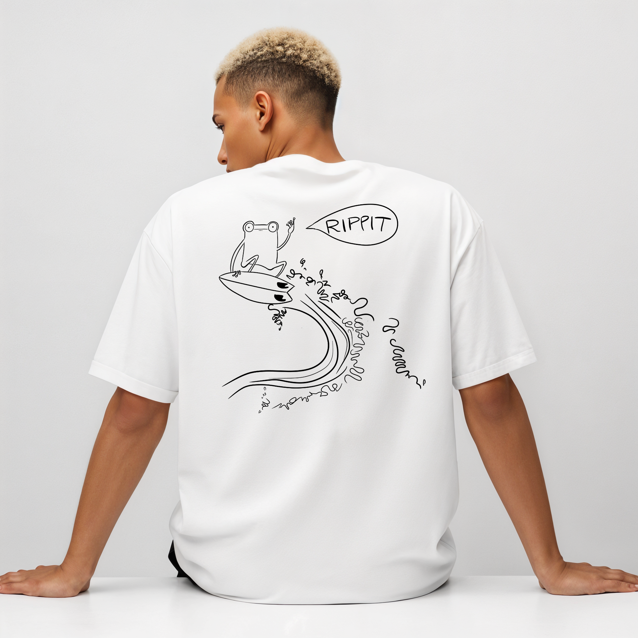 male mdoel wearing the surfjoy original rippit t-shirt with a design of a frog catching air on a wave