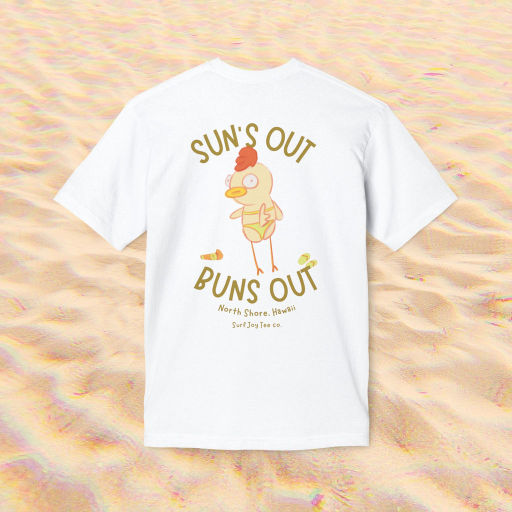 a funny beach t-shirt with a chicken in a bikini by text that reads 'suns out buns out' on a sand background