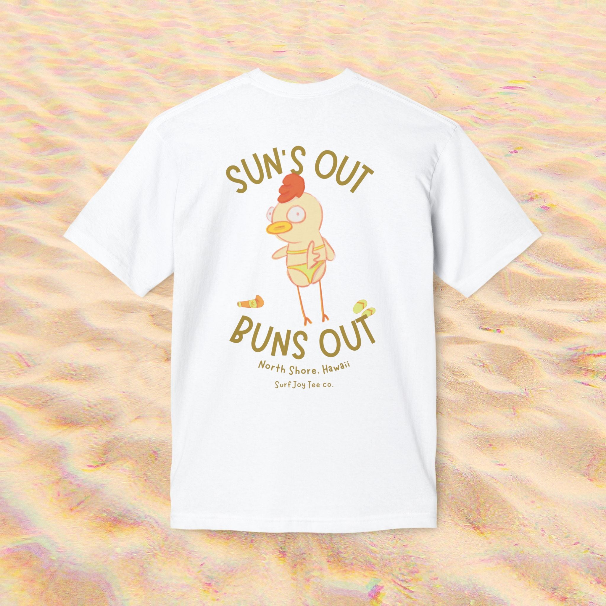 a funny beach t-shirt with a chicken in a bikini by text that reads 'suns out buns out' on a sand background