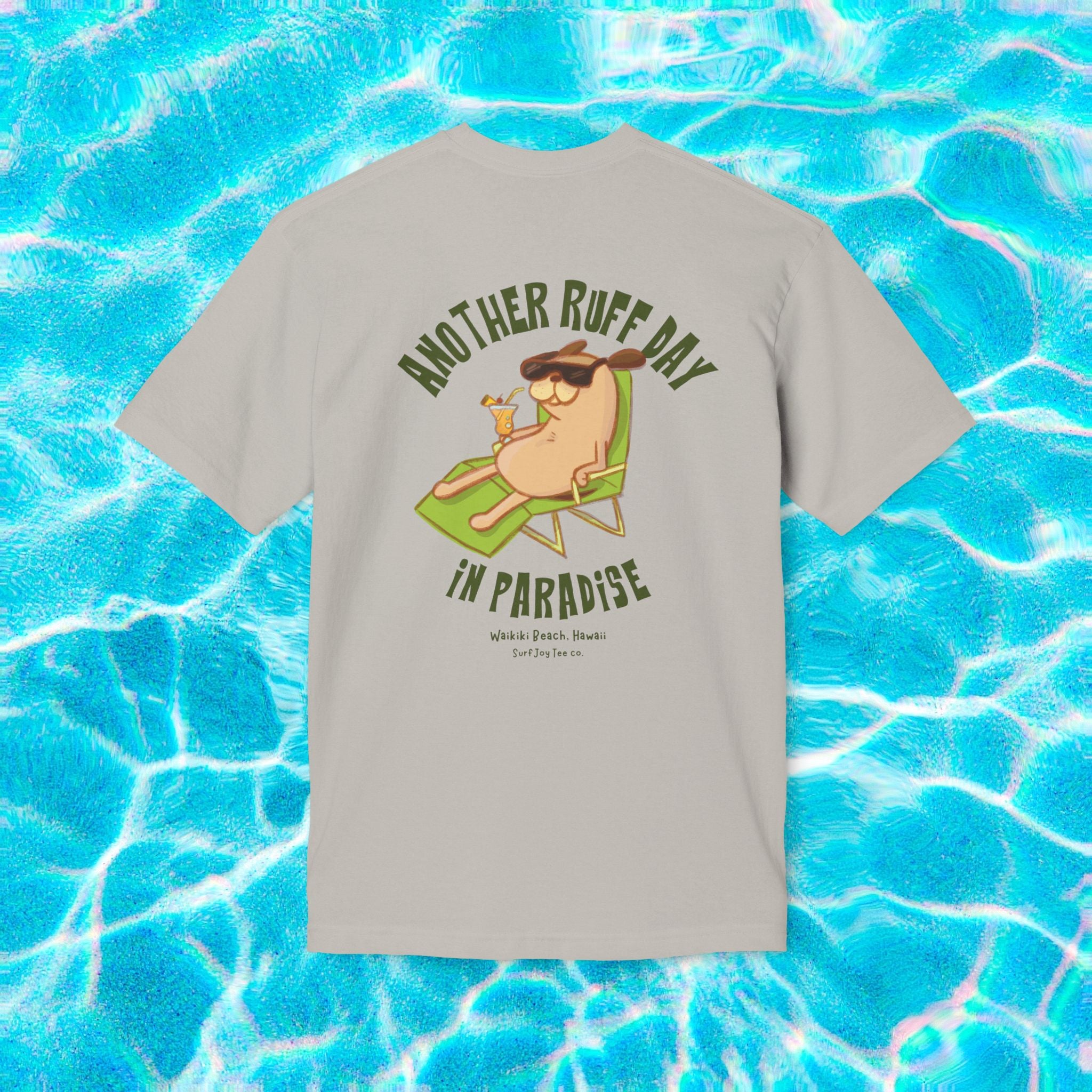a waikiki beach t-shirt featuring a dog in a beach chair with text thats says 'another ruff day in paradise' on a slate gray product variant